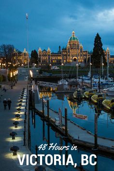 boats are docked in the harbor at night with lights reflecting off water and buildings in the background