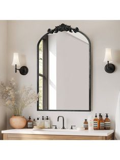 a bathroom vanity with a large mirror above it