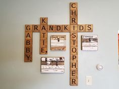 a cross made out of scrabble tiles on the wall