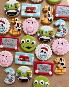 decorated cookies are arranged in the shape of farm animals and numbers for children's birthdays