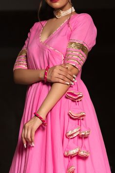 Romance with Indian dress in this vibrant pink color pure cotton angrakha anarkali suit set. With a regal intricate pattern of designing and gotta work on borders of suit and dupatta, you can never go wrong with this breathtaking ensemble. PRODUCT DESCRIPTION: Kurta & Pant: Coton Dupatta: Kota Doria Color: Pink No. Of Components : Set of 3 Embroidery Details: Lace Work Wash Care : Dry Clean Customization : Only Size and Length Of Product SKU#: 11403102PK Disclaimer: All our pieces are handcrafte Pink Anarkali Cotton Silk Salwar Kameez, Pink Cotton Silk Anarkali Set With Zari Work, Pink Cotton Sharara With Dupatta, Cotton Bollywood Dress With Gota Work, Pink Cotton Set With Mirror Work, Pink Cotton Sets With Mirror Work, Bollywood Style Cotton Dress With Gota Work, Pink Cotton Dress With Traditional Drape, Pink Chikankari Cotton Silk Anarkali Set