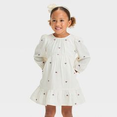 Update your little one's everyday wardrobe with this Hearts Long-Sleeve Dress from Cat & Jack™. This long-sleeve dress in a knee length sports a casual crewneck, soft gathers on the waist, a tiered hem and allover embroidered heart patterning for cute style. The soft cotton gauze fabric with lining lends comfortable all-day wear, and the keyhole behind the neck button closure makes dressing easy. Plus, the side pockets provide space for their favorite small toys. Cat & Jack™: Designed for all ch Cotton Gauze Fabric, Cozy Dress, Small Toys, Embroidered Heart, Long Sleeve Knit Dress, Denim Romper, Long Sleeve Print Dress, Gauze Fabric, Cute Style