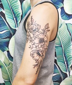 a woman with a flower tattoo on her arm