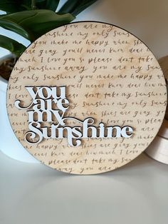 a wooden plaque with the words you are my sunshine written in cursive writing