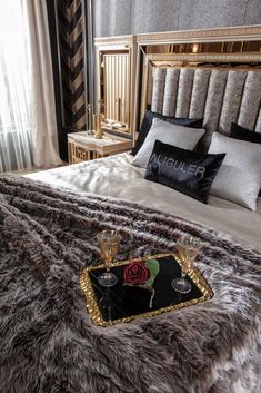 a bed with two champagne glasses on it