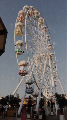 a large ferris wheel sitting next to a tall building