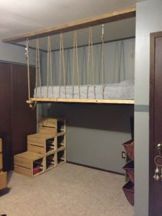 a loft bed with ladders and drawers in a room that has carpeted flooring