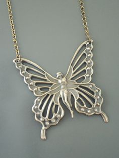 "Vintage Jewelry - Vintage Necklace - Butterfly Fairy Necklace - Butterfly Necklace - Brass Necklace - Boho Necklace - Chloe's Vintage handmade jewelry This is such a beautiful vintage brass necklace! A large Art Nouveau butterfly fairy. It hangs from a pretty vintage brass ladder chain necklace. So very bold and feminine. Chloe says, \"Wear it and feel fabulous!\" The pendant is 2 1/8\" wide and 2 1/4\" tall. You can choose the necklace length you would like at checkout. Thanks for visiting Chl Handmade Butterfly Necklaces In Fairycore Style, Handmade Butterfly Fairycore Necklaces, Handmade Fairycore Butterfly Necklaces, Handmade Fairycore Butterfly Necklace, Handmade Gold Fairy Necklace, Handmade Silver Fairy Necklace, Handmade Fairy Gold Necklace, Necklaces Butterfly, Necklaces Boho