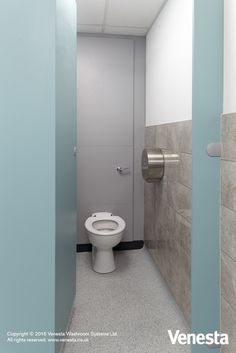 a white toilet sitting in a bathroom next to a wall