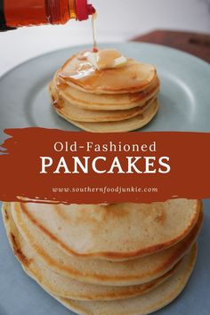 pancakes stacked on top of each other with syrup being drizzled over them