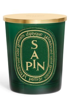 a candle that is green and gold with the word sa pin on it, sitting in front of a white background