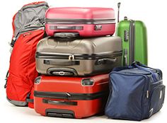 a pile of luggage sitting next to each other on top of a white floor covered in bags