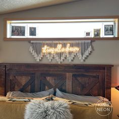 a bed with a wooden headboard and pillows