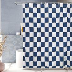 a blue and white checkered shower curtain in a bathroom