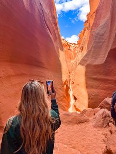 a woman taking a photo of herself in the slot called antelope canyon, arizona