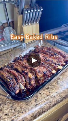 an easy baked ribs recipe is shown on the counter top in this video, you can see how to bake them