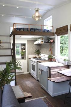 a kitchen with stairs leading up to the loft