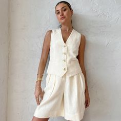 Elevate your summer style with our Beige Sleeveless Vest Two-Piece Suit for Women. This breathable and loose-fitting ensemble is designed to keep you comfortable and chic during the warmer months. The sleeveless vest adds a touch of sophistication, while the cotton linen fabric ensures breathability and comfort. Whether you're dressing up for a special occasion or opting for a relaxed summer look, this two-piece suit has you covered. The versatile beige color complements various outfits and occa Linen Design, Two Piece Shorts Set, Linen Vest, Mode Costume, Plain Style, Short Vest, Casual Suit, Office Casual, Sleeveless Vest