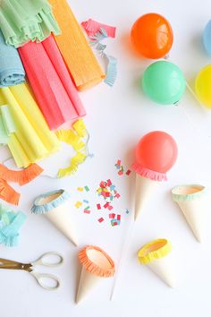 colorful party decorations and supplies laid out on a white surface