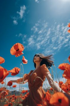 a woman standing in a field of flowers