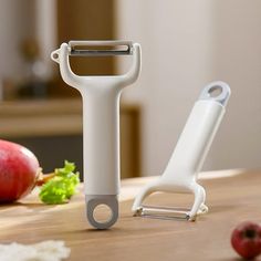 an electric hair clipper sitting on top of a wooden table next to fruit and vegetables