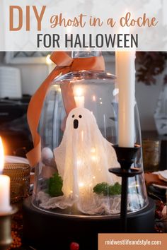 a lighted ghost in a cloche for halloween with text overlay that reads diy ghost in a cloche for halloween