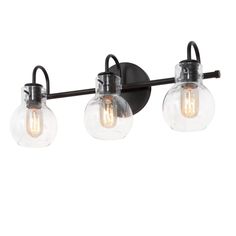 three light bathroom fixture with glass globes and black metal frame, on an isolated wall