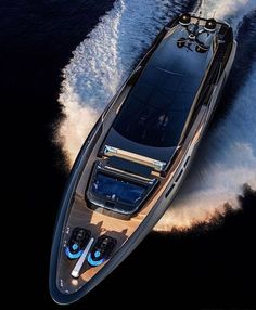 an aerial view of a motor boat in the water with its wakers behind it