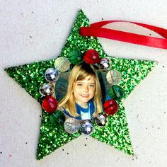 a christmas ornament with a star shaped photo hanging from it's side