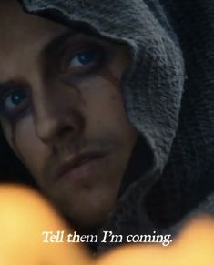 a man with blue eyes and a hoodie over his head