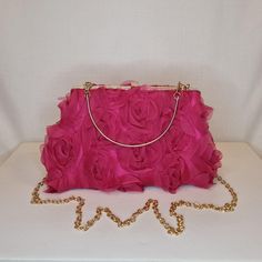 Womens fuschia pink all-over ruffle floral rose pattern evening clutch bag with gold metalwork and top closing clasp Can be used with or without long shoulder chain or small handle (both included) size approx- H 14cm x W 24cm Optional Dust Bag: White lightweight soft polyester portable travel dust bag pouch, suitable for protecting items from dust, dirt, hairs and scratches when not in use size approx- L 47cm x W 31.5cm Material: 100% polyester Please note, there is a cut in the top corner of th Pink Evening Bag With Chain Strap, Pink Evening Bag With Chain Strap For Events, Pink Clutch With Chain Strap For Events, Pink Clutch With Chain Strap For Formal Occasions, Formal Pink Clutch With Chain Strap, Pink Feminine Party Clutch, Feminine Pink Clutch For Evening, Feminine Pink Evening Clutch, Chic Pink Bag For Wedding Guest