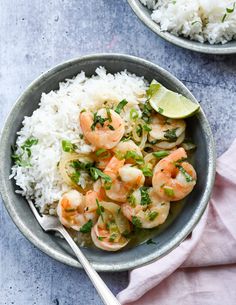 two bowls filled with shrimp and rice on top of a table