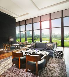 a living room filled with furniture and large windows