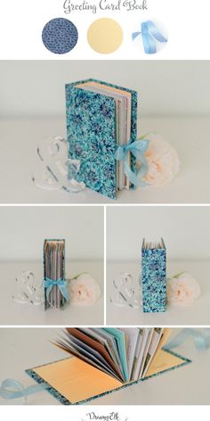 an open book sitting on top of a table next to some flowers and ribbones