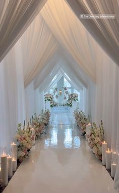 the aisle is lined with candles and flowers