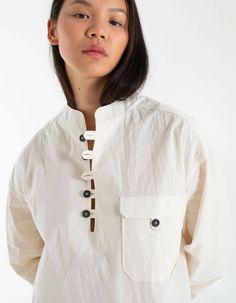 Collarless shirt in ecruLoose, oversized cutLow cut, button-down necklineBalloon style sleevesMade in France100% cottonAnna is 176cm and wears a size S Oversized Cotton Blouse With Buttons, Neutral Button-up Cotton Blouse, Neutral Cotton Button-up Blouse, Neutral Cotton Button-up Tops, Beige Tops With Button Cuffs For Everyday, Casual Beige Blouse With Button Cuffs, Oversized White Blouse With Placket, Beige Shirt With Button Cuffs For Daywear, Oversized Tops With Button Cuffs For Day Out