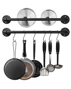 an assortment of cooking utensils hanging on a wall