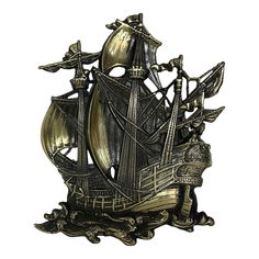 a metal sculpture of a ship with sails