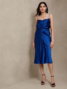 This midi skirt is made from our signature silk charmeuse, expertly cut on the bias for exceptional drape that showcases a wrap detail at the waist.  Column fit.  Zip closure.  Fully lined.  Column fit.  Midi length.  Skirt length (size S): Regular Model: Size 2, 5'10" (178cm). Blue Silk Skirt, Silk Midi Skirt, Fashion Capsule Wardrobe, Christmas Party Outfit, The Perfect Christmas, Fashion Capsule, Silk Charmeuse, Silk Skirt, Blue Silk