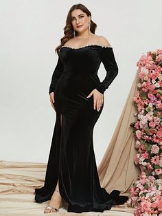 a woman in a black dress posing for the camera with her hands on her hips