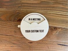 a wooden sign that says in a meeting your custom text