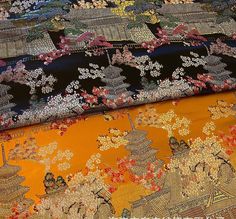 three different types of fabric with flowers and leaves on the top one is black, orange, yellow and red