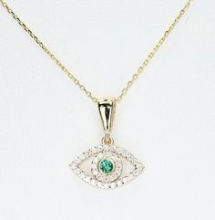 14k Solid Gold Emerald Evil Eye Necklace, Real Gold Dainty Eye Pendant, Evil Eye Necklace For Her, with lab grown zambian emerald and premium grade D Color (colorless) VS/SI clarity moissanites.  All of the materials including pendant and chain are 14k Solid Gold. This is a dainty necklace. Dimensions - Chain width: 1.30 mm.  Pendant Width: 13.6 mm.  Pendant Height: 16.8 mm. 💙 Our jewelry is handcrafted with love and great care at San Francisco Bay! All of our items are 14k stamped for authenticity. 💙 You will receive them exactly as pictured. We don't use any filters, all photos are authentic and unedited. 💙 The material is 14k solid gold and should not be confused with gold plating or filling. It won't tarnish or fade over time. 💙 Our chain is a special diamond cut chain with 1.30 mm Handmade 14k Gold Green Necklace, Handmade Green 14k Gold Necklace, Gold Spiritual Round Emerald Necklace, Spiritual Gold Emerald Necklace, Gold Spiritual Emerald Necklace, Yellow Gold Evil Eye Spiritual Necklace, Yellow Gold Evil Eye Round Pendant, Alexandrite Jewelry, Diamond Evil Eye