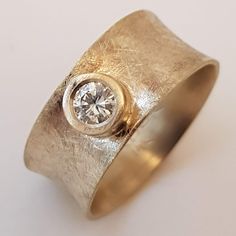 a gold ring with a diamond in the center