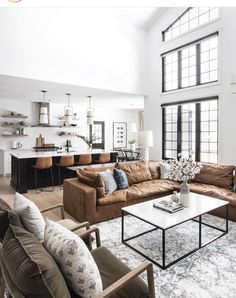 a living room filled with furniture and lots of windows