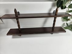 two wooden shelves with plants on top of them