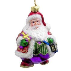 a glass ornament with a santa clause holding a bag and a cell phone