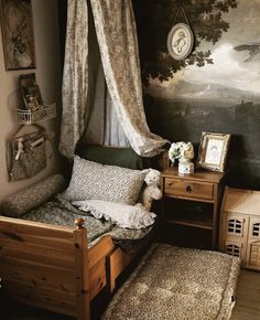 a bedroom with a bed, nightstands and pictures on the wall above it in front of a painting