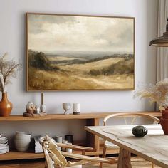 a painting hanging on the wall above a dining room table