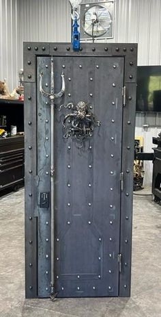 an open metal door in the middle of a room